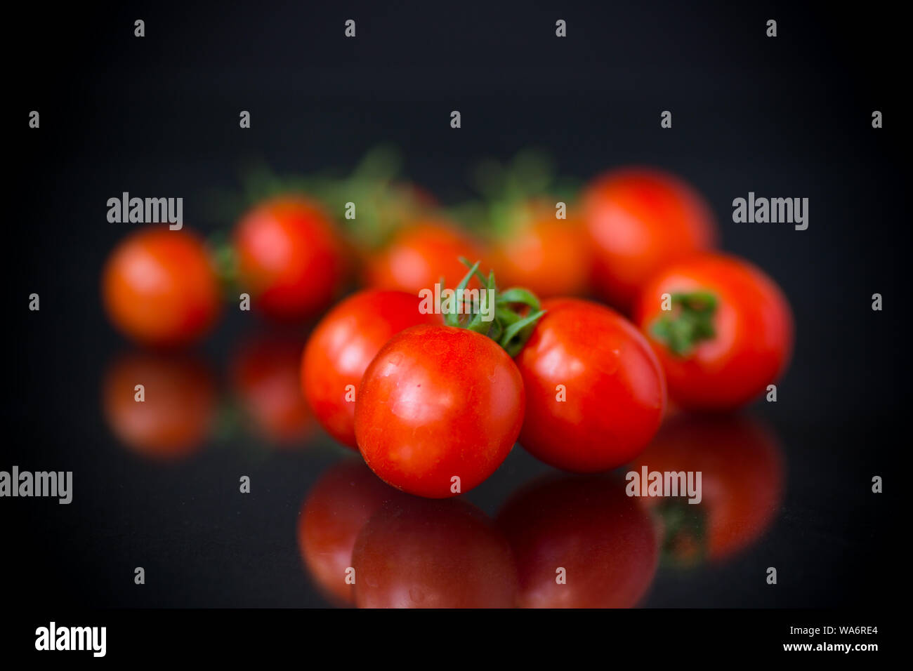 Ripe cocktail tomatoes on black hi-res stock photography and images - Alamy