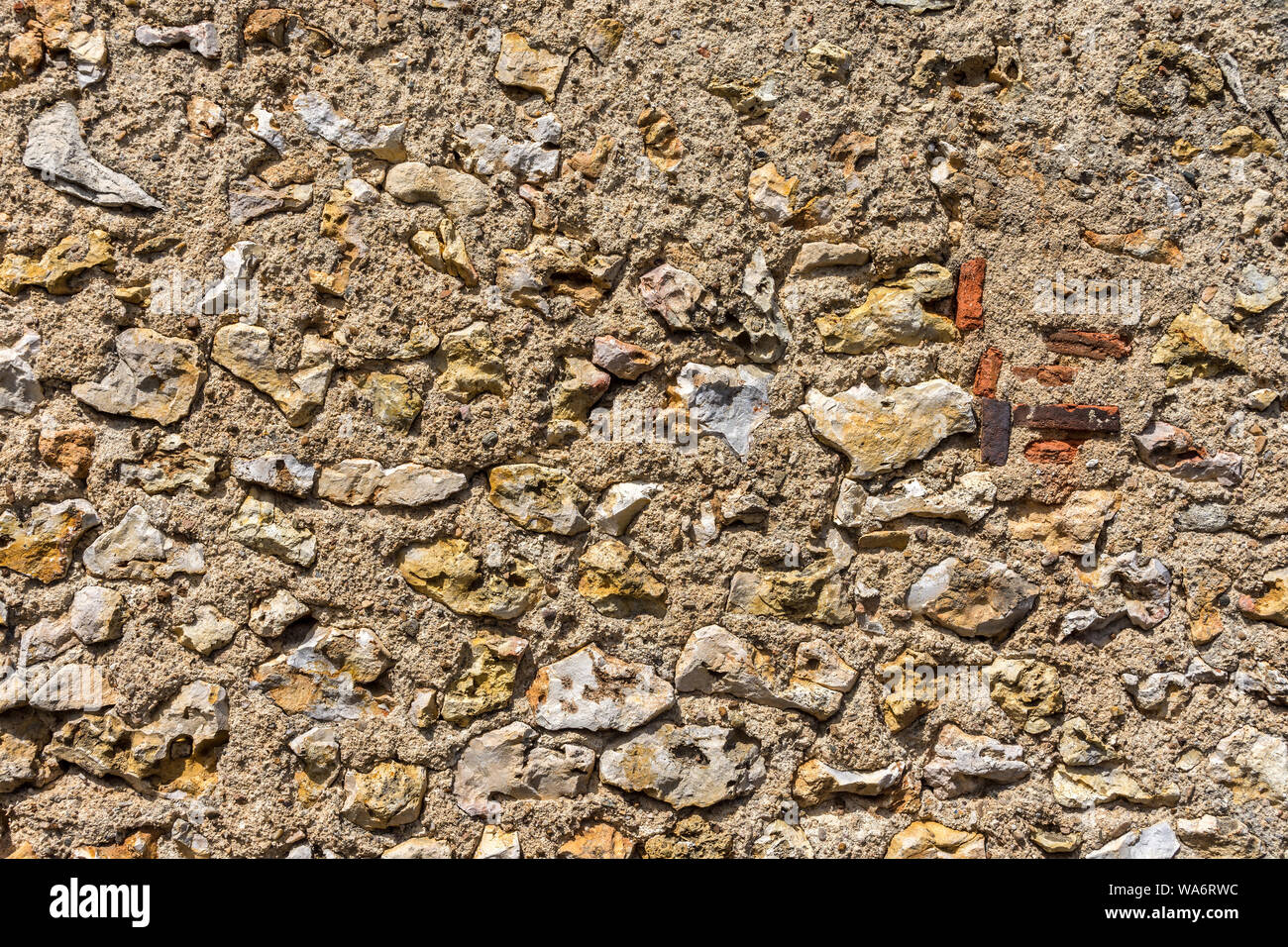 Rough random textured stone wall - France. Stock Photo