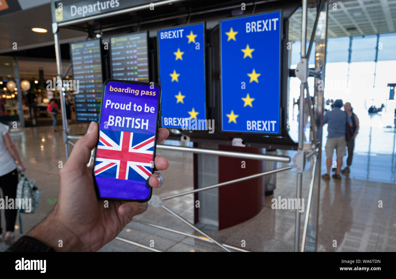 Hand holding a smartphone with UK boarding pass on the screen and EU flag on the info panels representing the Brexit. Stock Photo
