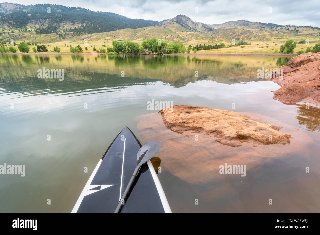 stand up paddleboard on a mountain lake Horsetooth Reservoir in