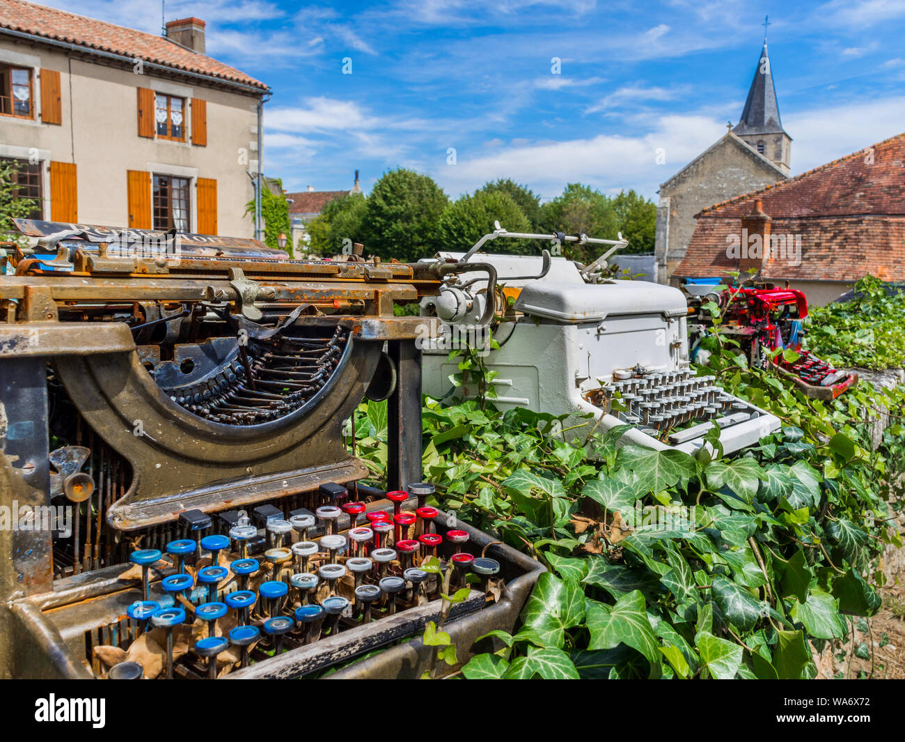 Old typewriters on outdoor display in 'book city' of Montmorillon, Vienne, France. Stock Photo