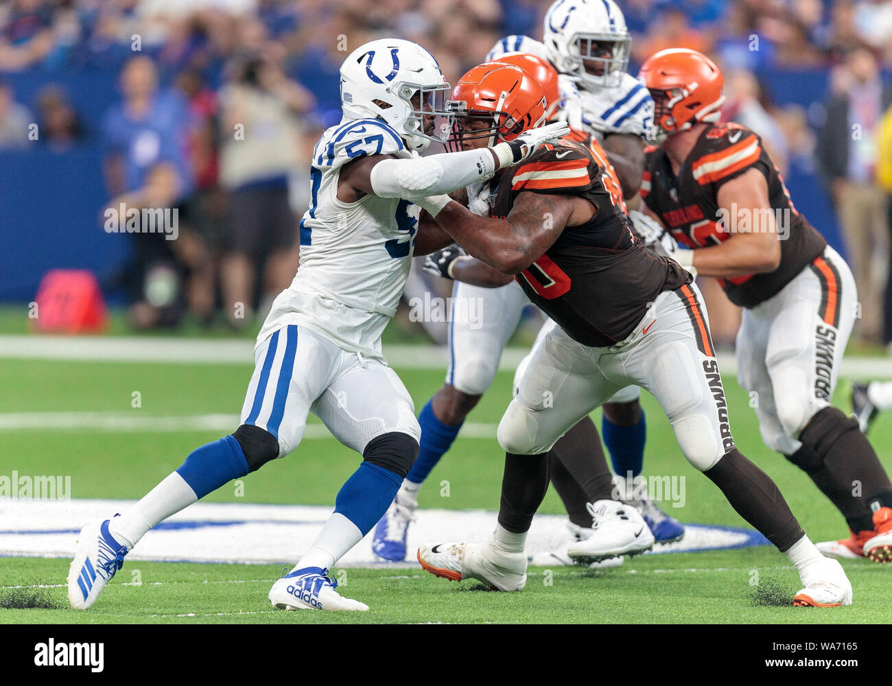Indianapolis, USA. 17 August 2019.  Indianapolis Colts defensive lineman Kemoko Turay (57) and Cleveland Browns offensive lineman Kendall Lamm (70) battle at the line of scrimmage during NFL football preseason game action between the Cleveland Browns and the Indianapolis Colts at Lucas Oil Stadium in Indianapolis, Indiana. Cleveland defeated Indianapolis 21-18. John Mersits/CSM. Credit: Cal Sport Media/Alamy Live News Stock Photo
