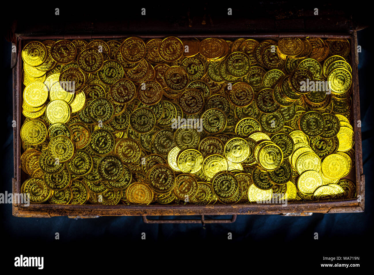 Stacking Gold Coin in treasure chest on black background Stock Photo