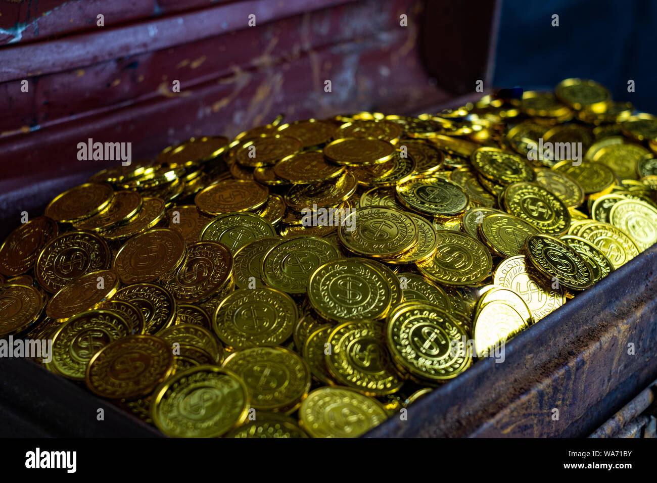 Stacking Gold Coin in treasure chest on black background Stock Photo