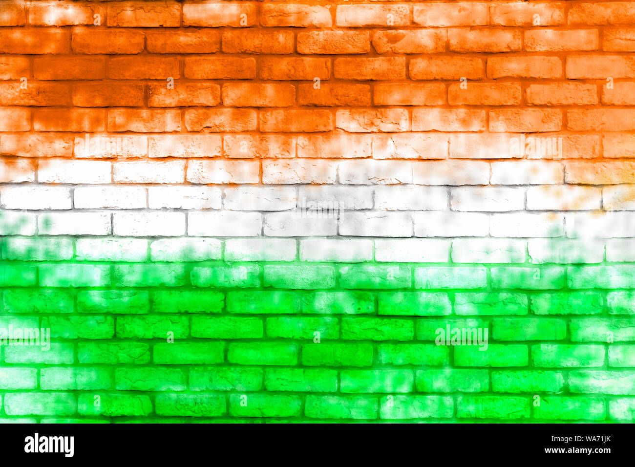 Colorful brick wall background. Walls painted with the India flag color. Stock Photo