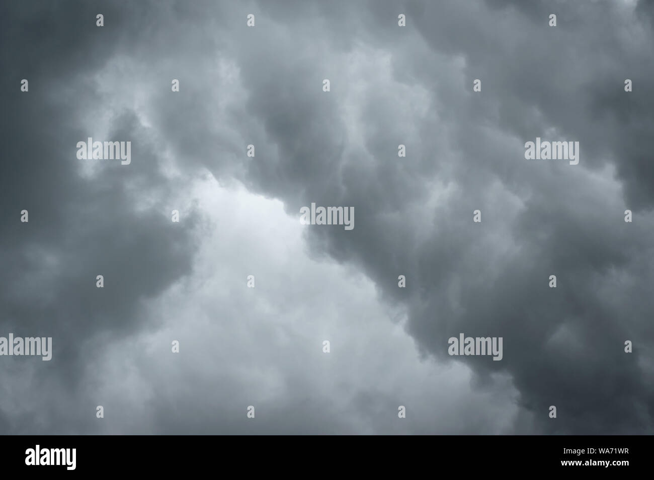 Dark sky with thunderstorm while raining. Dramatic black clouds before the rain. Stock Photo