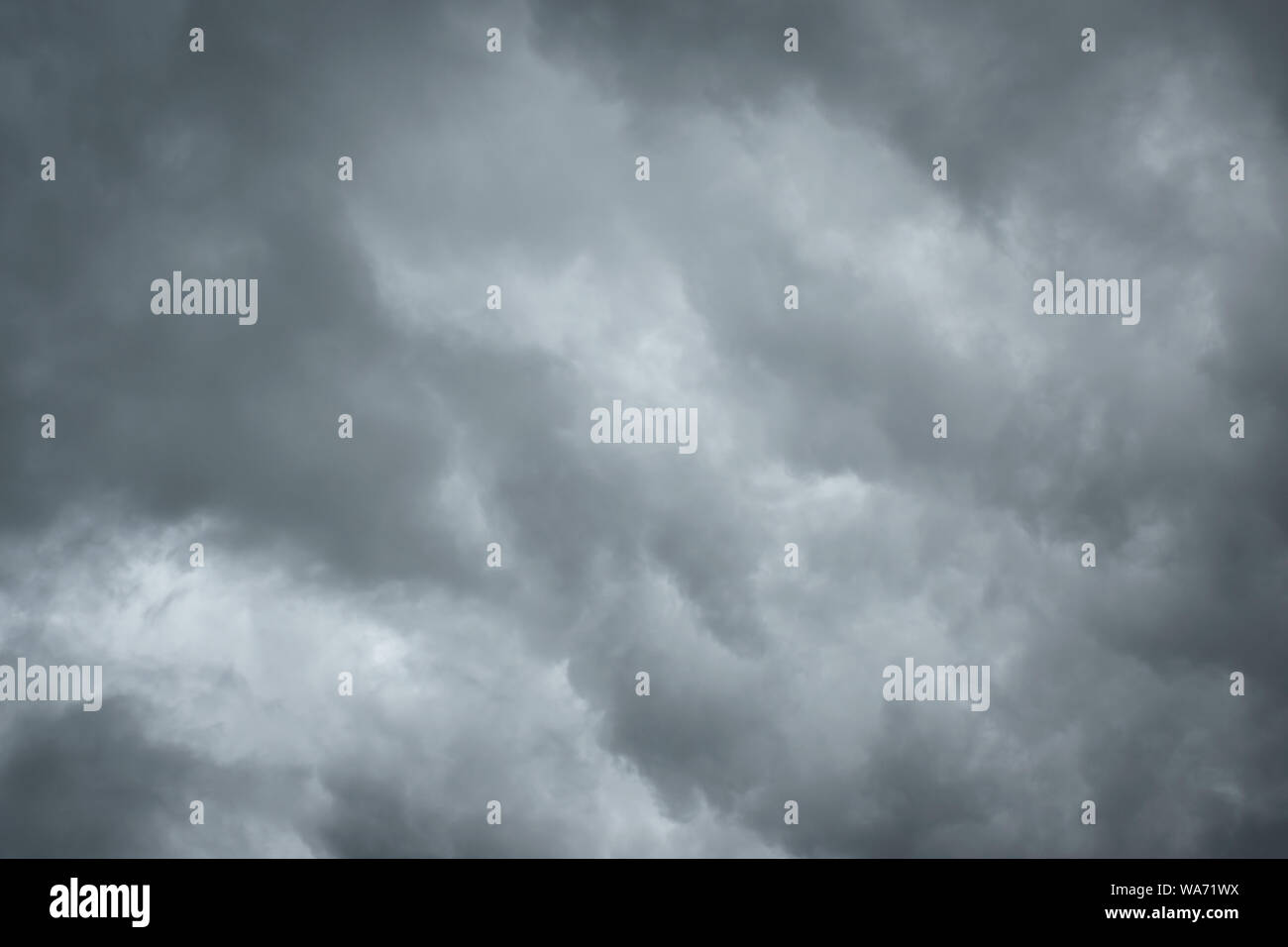 Dark sky with thunderstorm while raining. Dramatic black clouds before the rain. Stock Photo