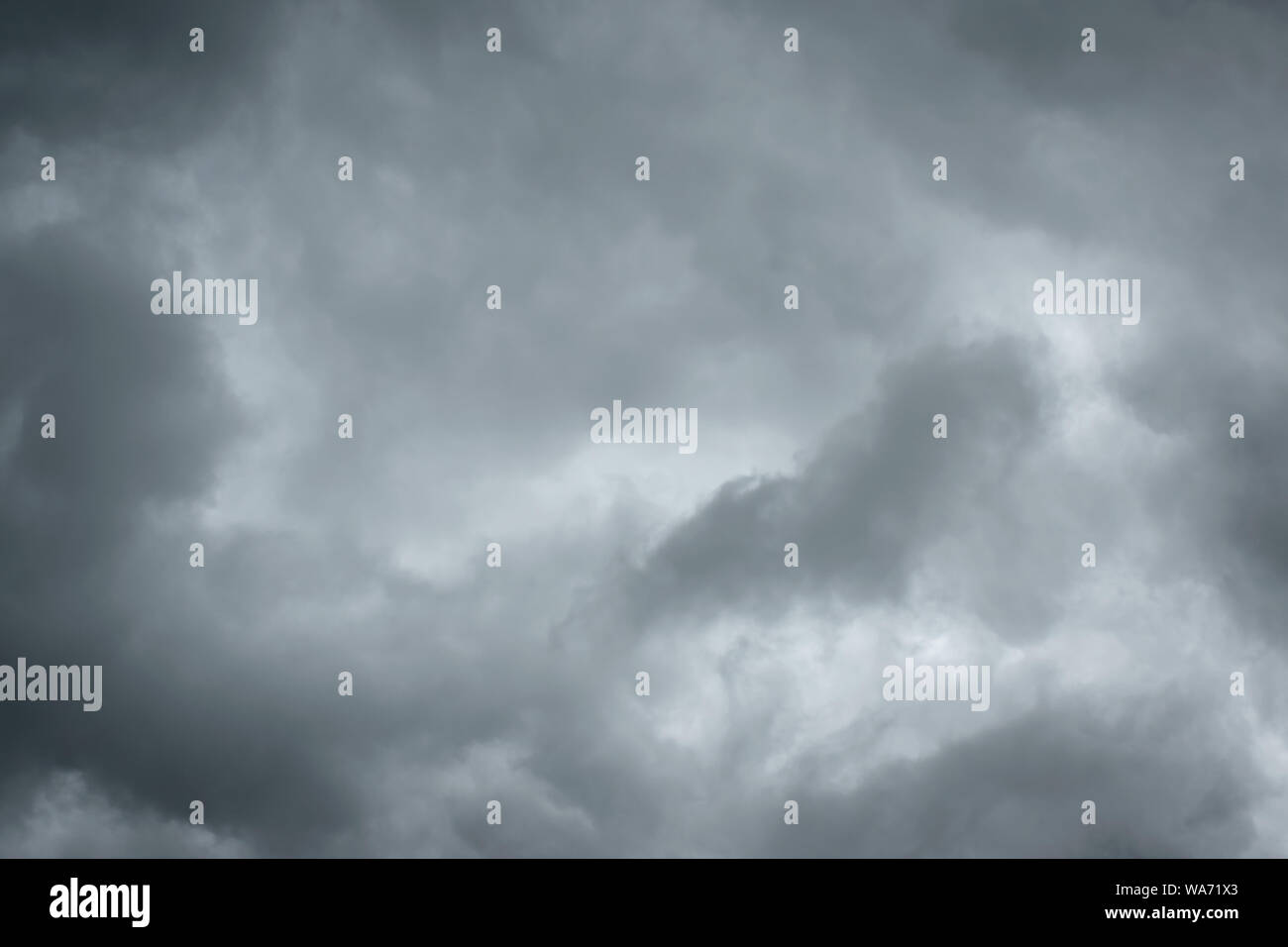Dark sky with thunderstorm while raining. Dramatic black clouds before the rain. Stock Photo