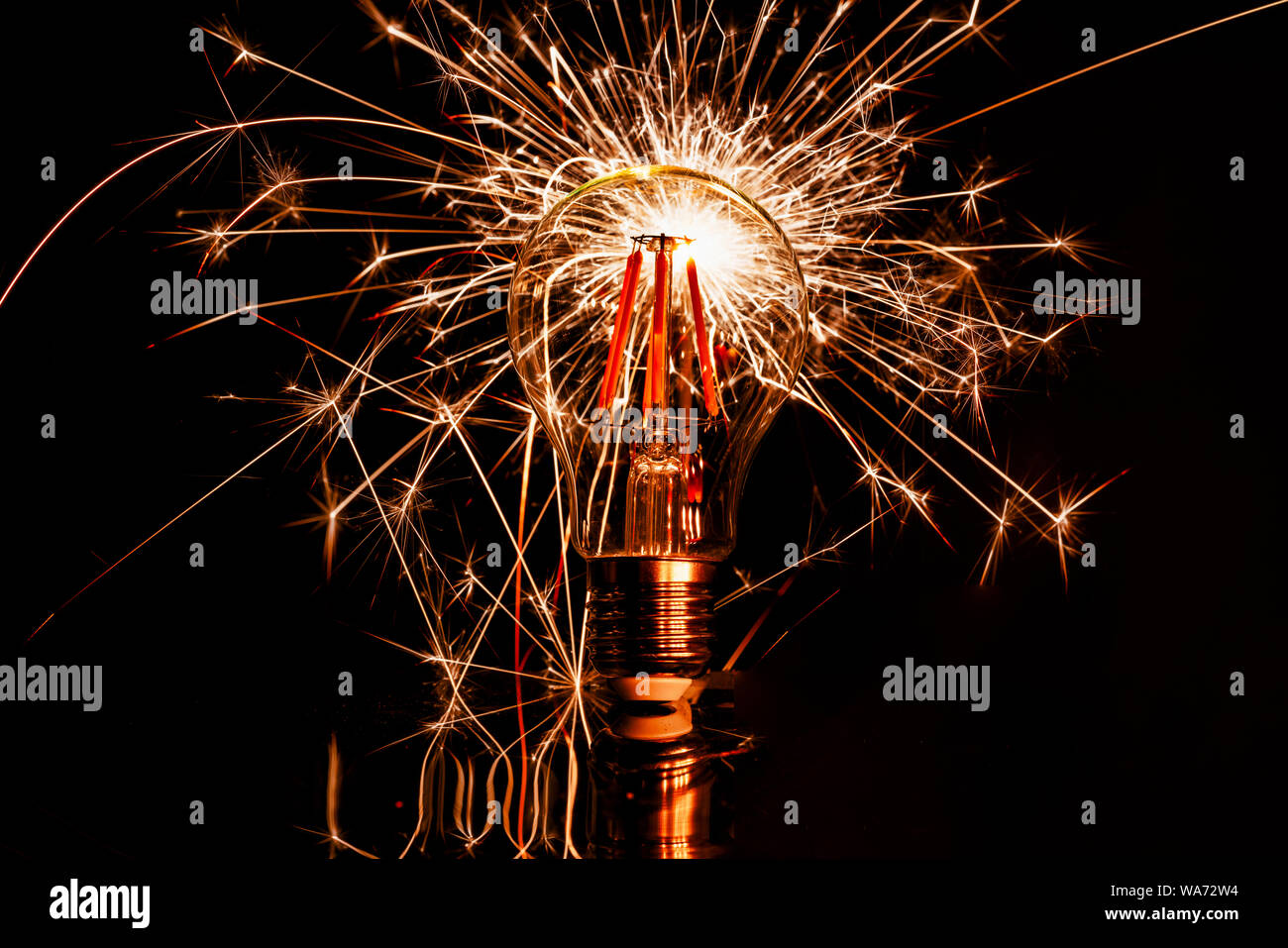 Fireworks sparkler behind LED light bulb burns Stock Photo Alamy