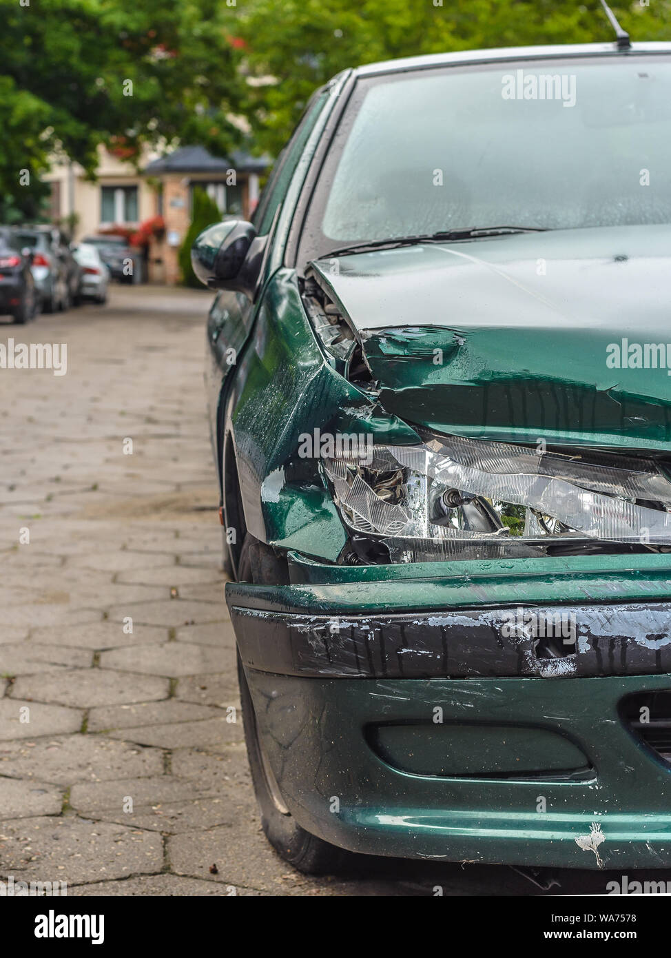 Car crash or accident. Front fender and light damage and scratchs on bumper. Broken vehicle detail or close up. Stock Photo