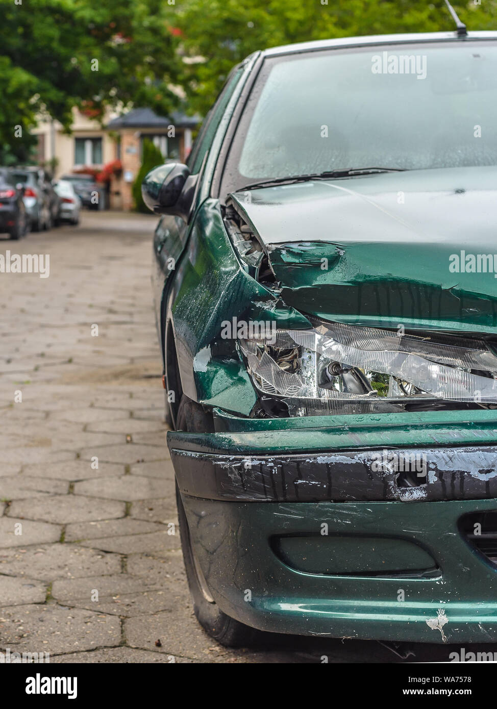 Broken Car after a Crash. Damaged Wing and Headlamp of a Car