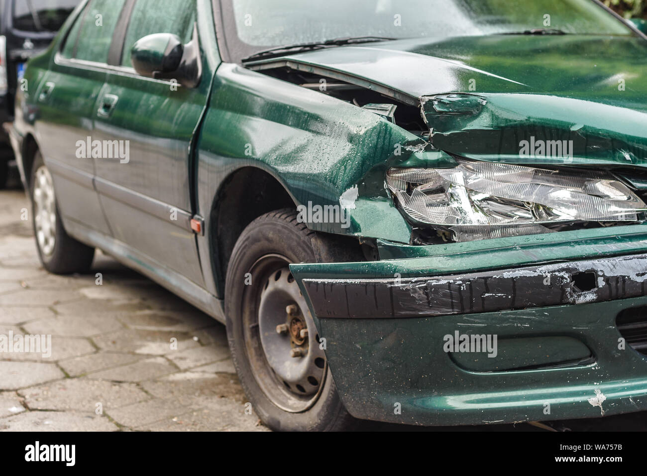 Car crash or accident. Front fender and light damage and scratchs on bumper. Broken vehicle detail or close up. Stock Photo