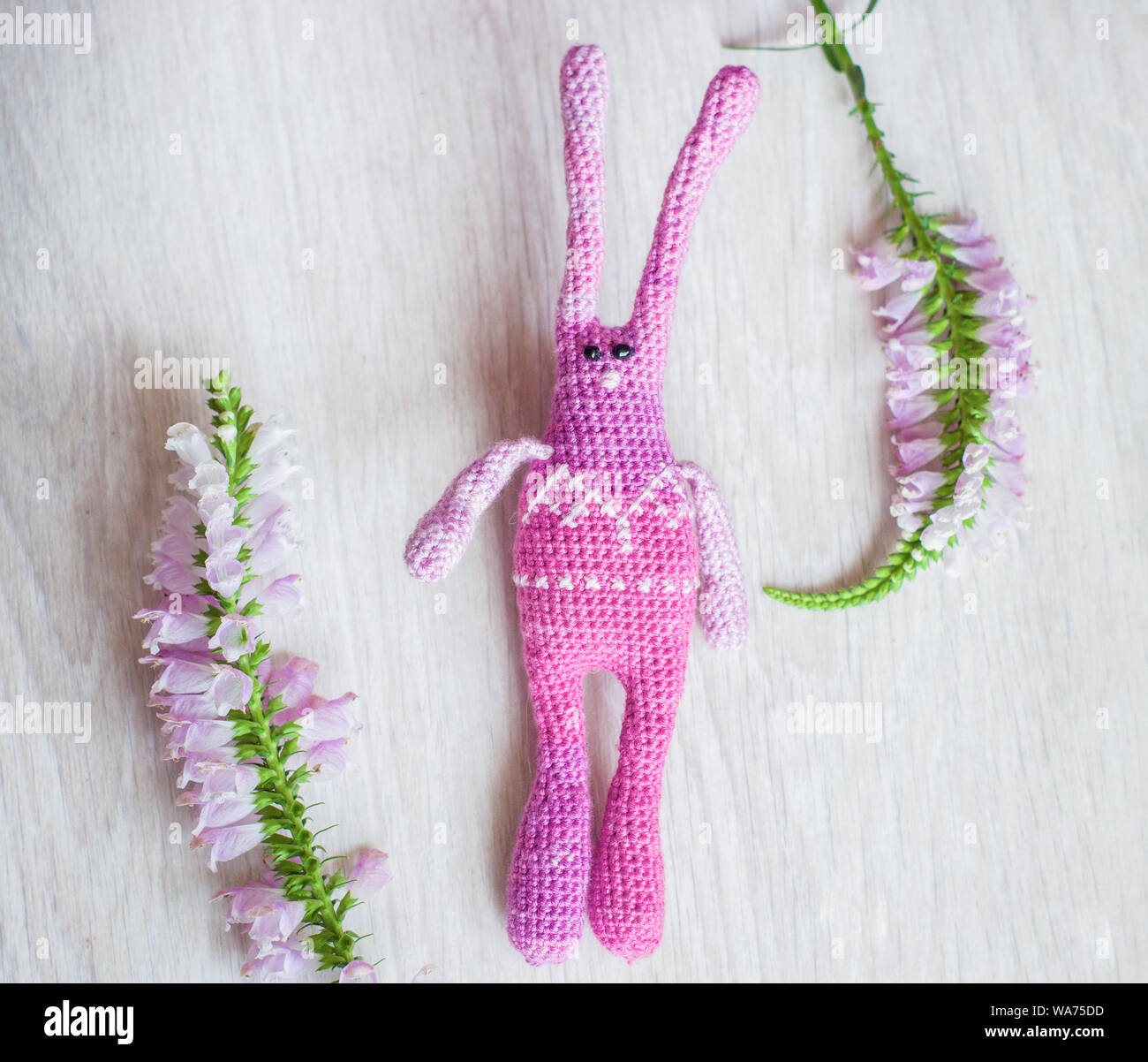Crafted Rabbit Creative Knitted pink striped handmade crafted rabbit. Children's toy. Crochet ...