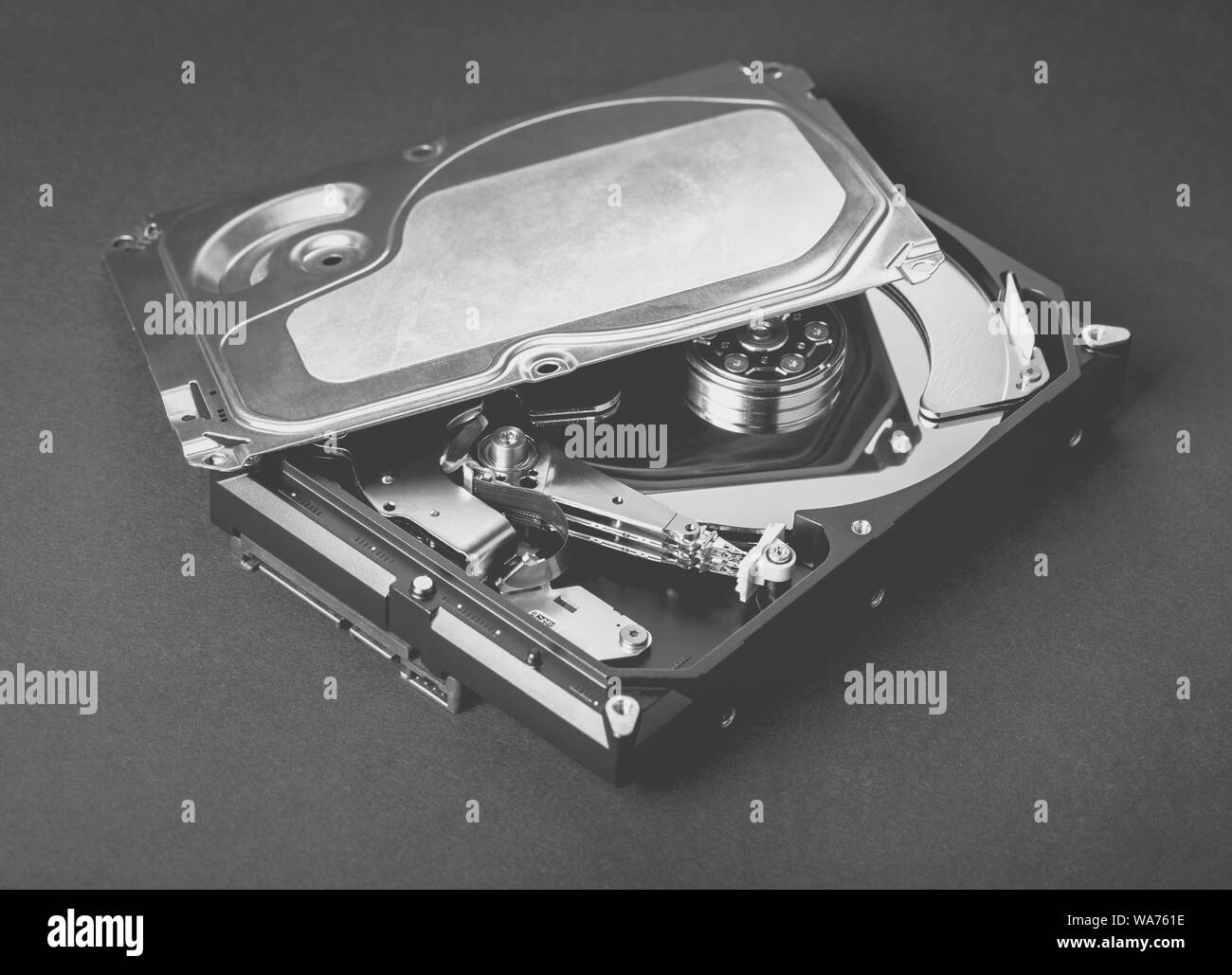 disassembled computer hard drive on black background Stock Photo