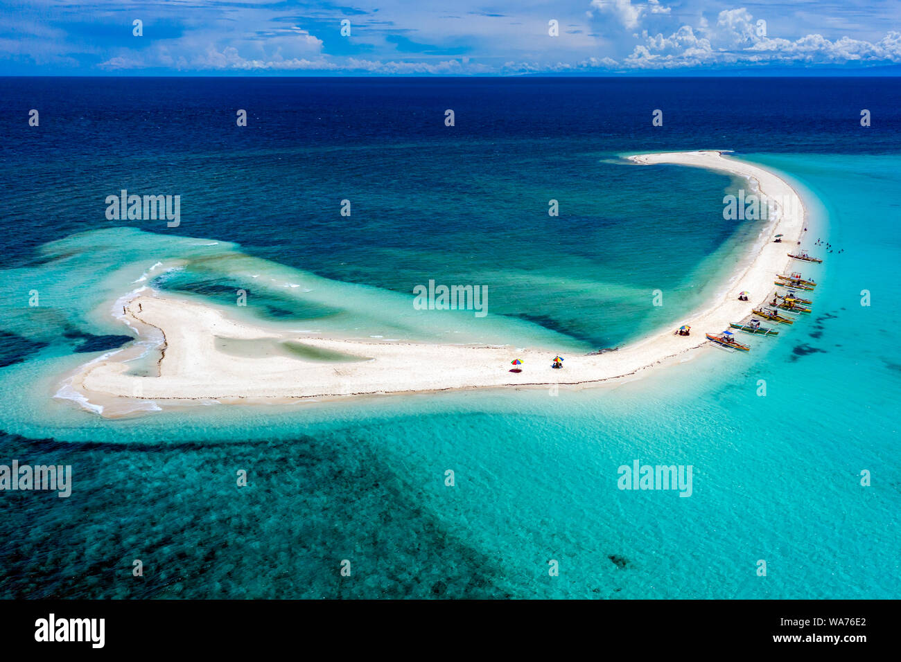 Aerial drone view of a spectacular sandbar surrounded by coral reef located off a tropical