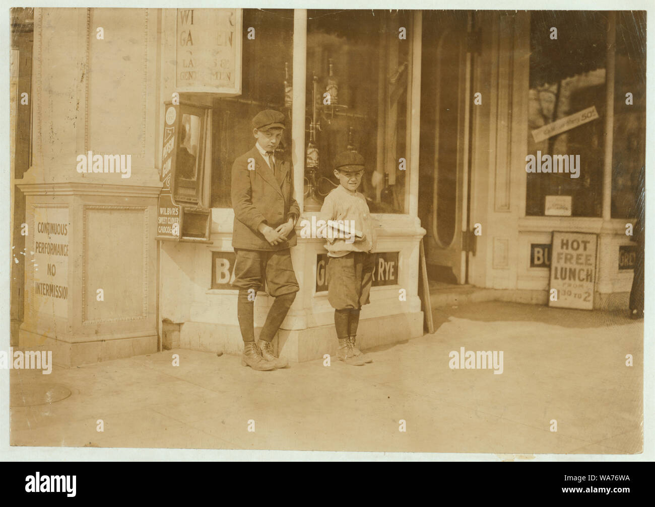 A 10 yr. old newsie, who had just been selling in this saloon for the other boy, his boss, E. Street, near 13th, Washington, D.C., The boss is Herbert Solomon, 452 D. St., N.W., Washington, D.C. 12 yrs. old. On April 19th I found Herbert selling at 1 A.M. The younger is Sam Goldstein, 458 P Street, N.W. Abstract: Photographs from the records of the National Child Labor Committee (U.S.) Stock Photo
