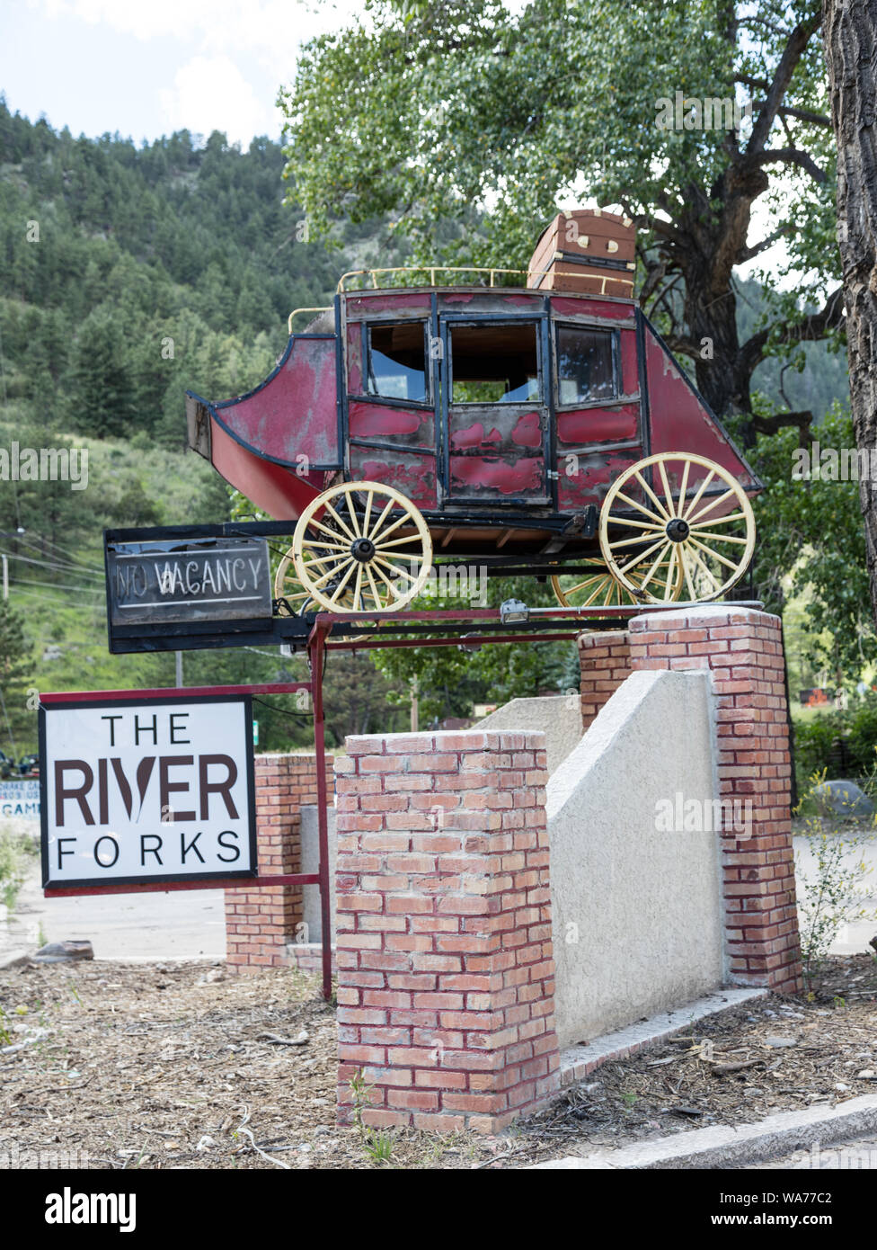 A  catchy sign promoting the nearby River Forks Inn in the little town of Drake, along U.S. 34, the route to Rocky Mountain National Park between Loveland and Estes Park in Larimer County, Colorado Stock Photo