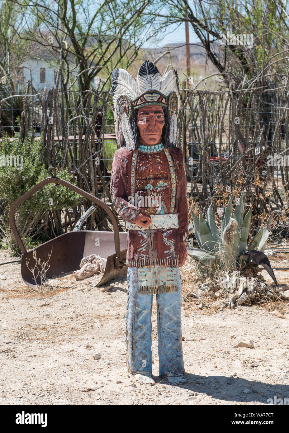 A carved indian figure near the ghost town, some of which is still occupied and some of which consists of ruins of the Chisos quicksilver-mining company which operated from 1905 into the early 1940s, and the residences of those who worked there. Terlingua, Texas Stock Photo