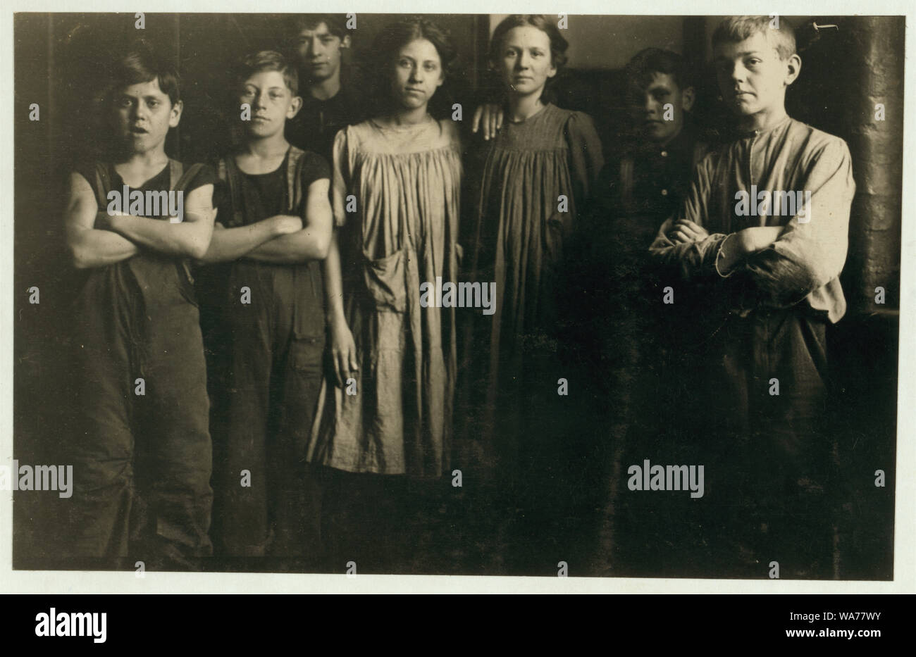 A few of the small girls and boys (not the smallest ones) that I found working in the spinning room of one of the Amoskeag Mfg. Co. mills at Manchester, N.H. Photo taken at 1:00 p.m., May 21, 1909, in hallway of spinning room. Many others there and in the other mills. Smallest boy (on left hand) is Geroge Brown, No. 1 Corporation. Corner of Granite and Bedford Sts. Next is, Eugene Lamy, 16 Marion St. Girls: Melvina Proulx, 145 Cartier St. Laura Oclair, 145 Cartier St. Abstract: Photographs from the records of the National Child Labor Committee (U.S.) Stock Photo