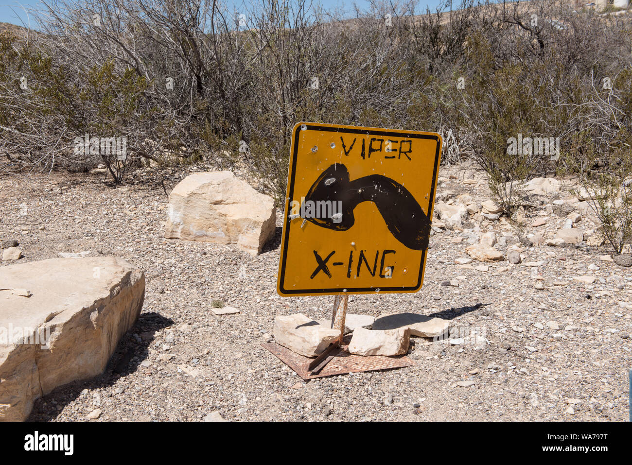 A whimsical pedestrian-crossing sign in the ghost town, some of which is still occupied and some of which consists of ruins of the Chisos quicksilver-mining company which operated from 1905 into the early 1940s, and the residences of those who worked there. Terlingua, Texas Stock Photo