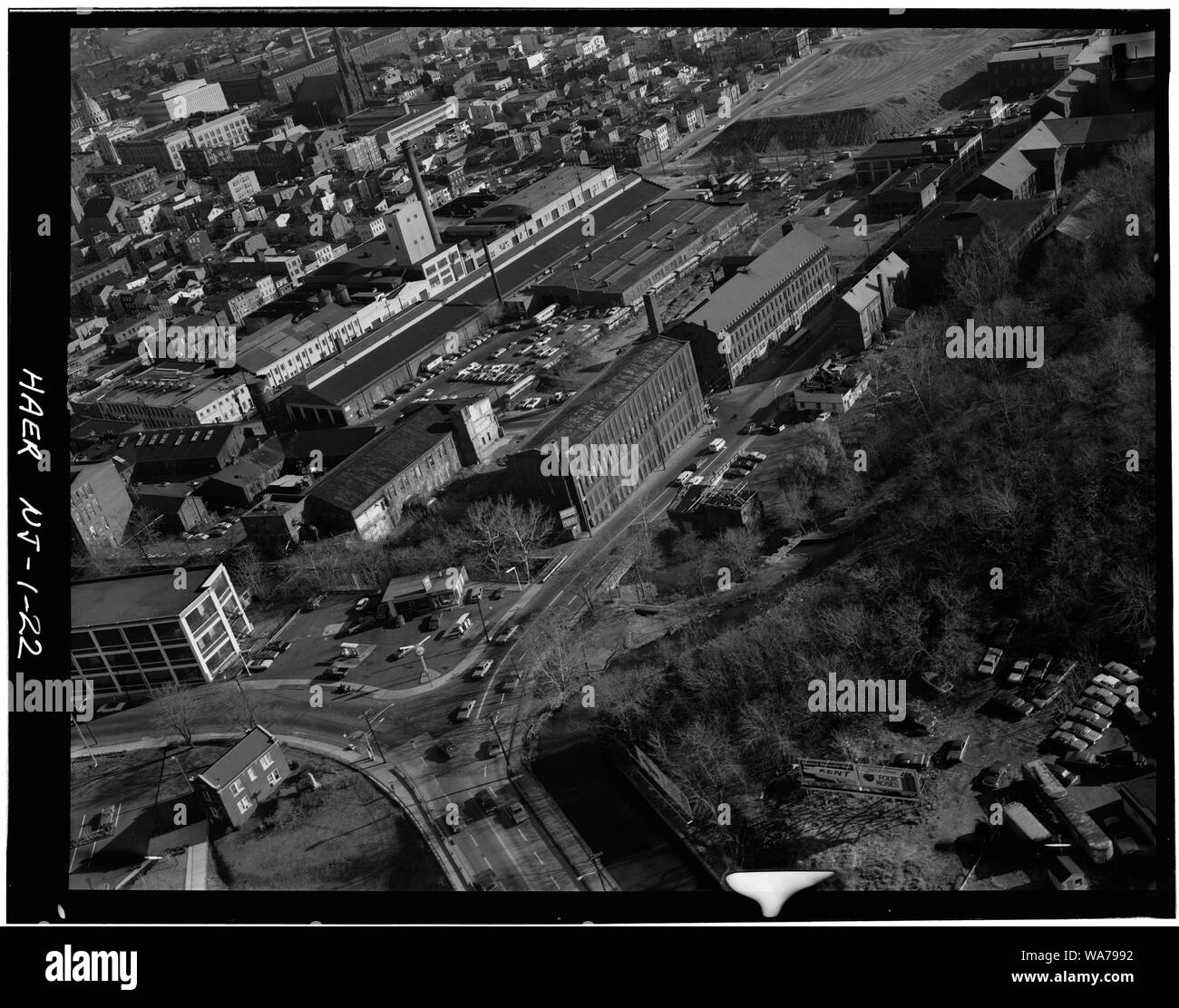 AERIAL VIEW LOOKING EAST SHOWING GRANT LOCOMOTIVE WORKS, UNION WORKS (ROSEN MILL), ROGERS LOCOMOTIVE AND MACHINE COMPANY AND IVANHOE MILL WHEELHOUSE UNDER RESTORATION. - Great Falls-S. U. M. Historic District, Oliver Street, Paterson, Passaic County, NJ Stock Photo