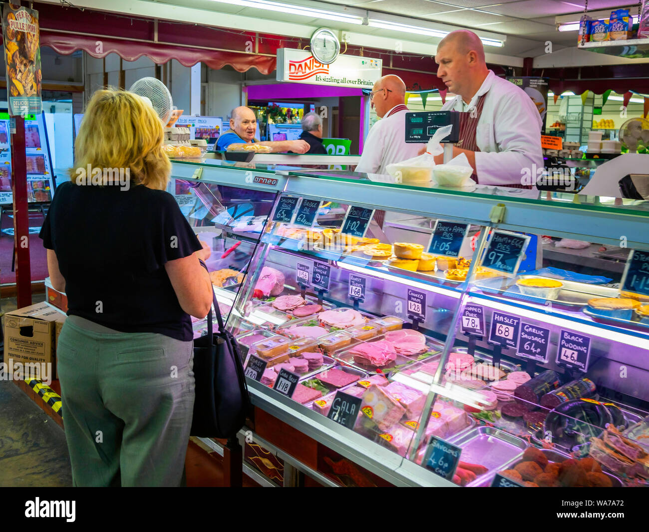 Man and woman buying from David Jackson Butchers Ltd meat and pie stall