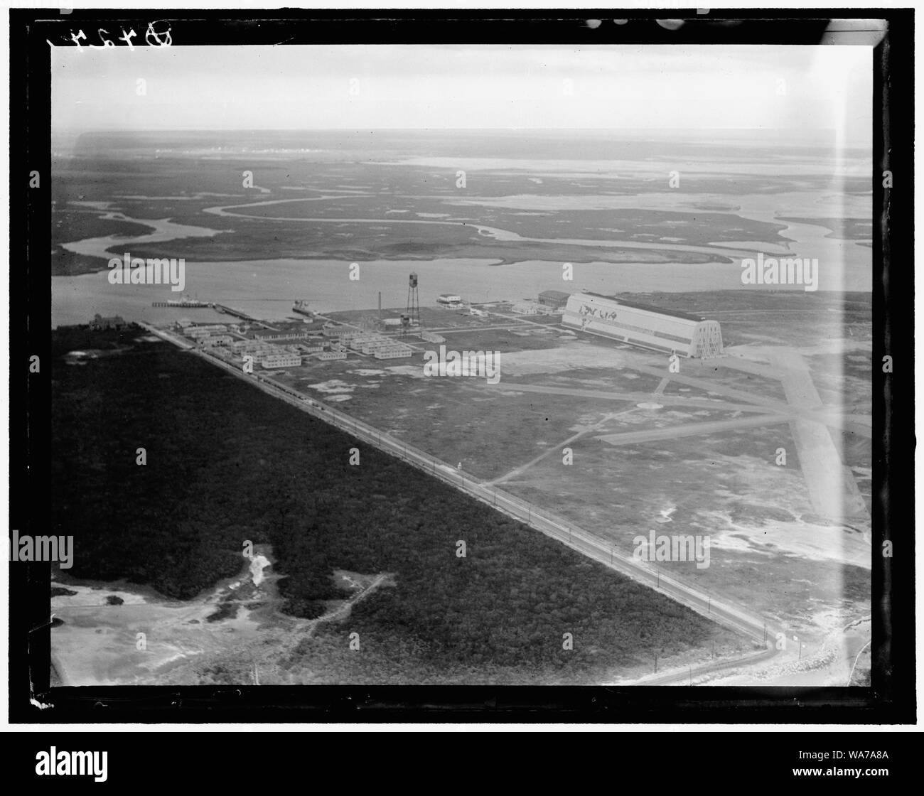 Air shot, Cape May (N.J.) Coast Guard Station Airport, showing new runways and the old air ship hanger built by the Navy for one of the treaty Zeps after the World War, but now not in use Stock Photo