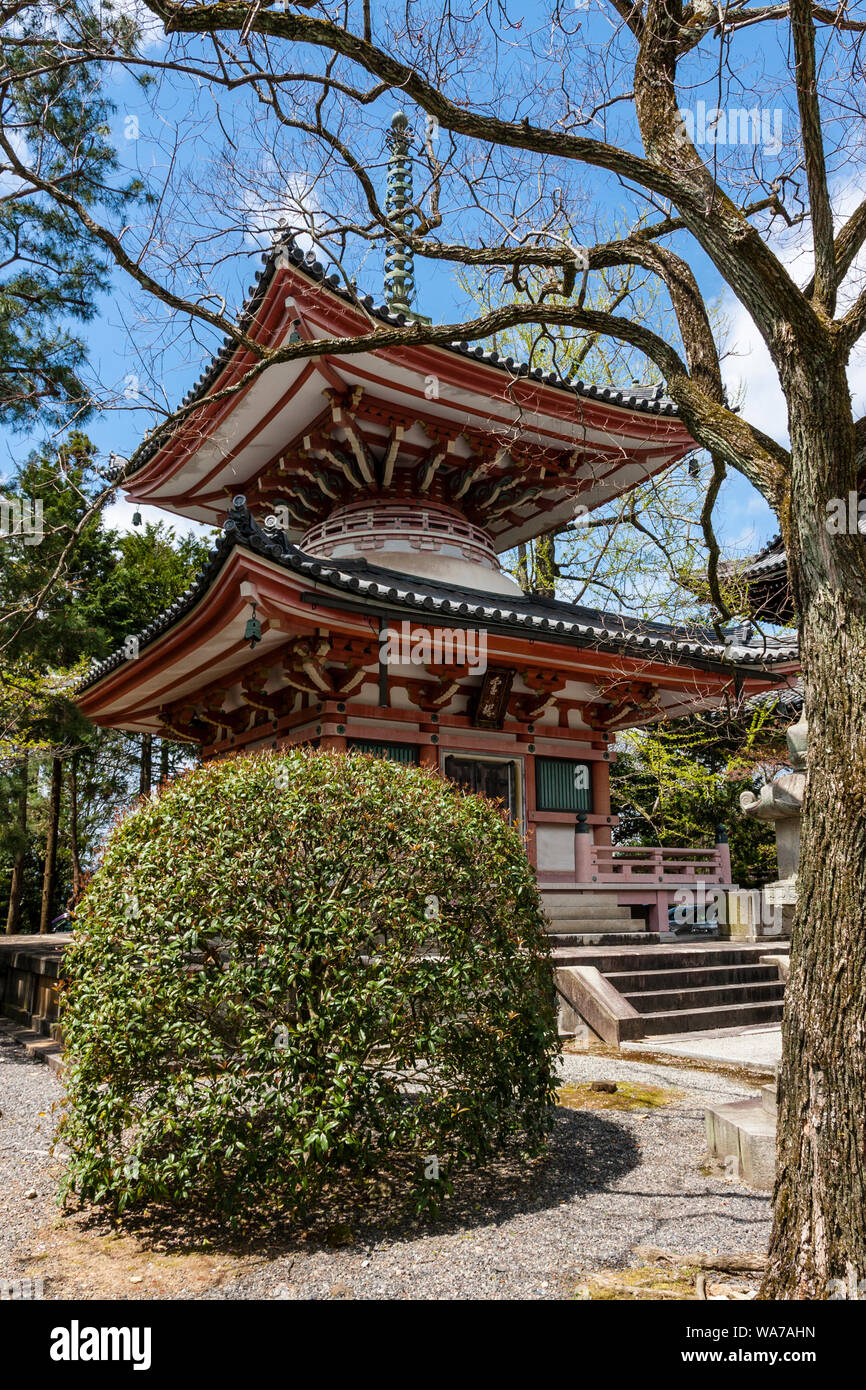 White and faded vermillion Tahoto, a two story Japanese pagoda at the Chion in temple in Kyoto during the springtime with blue sky behind. Stock Photo