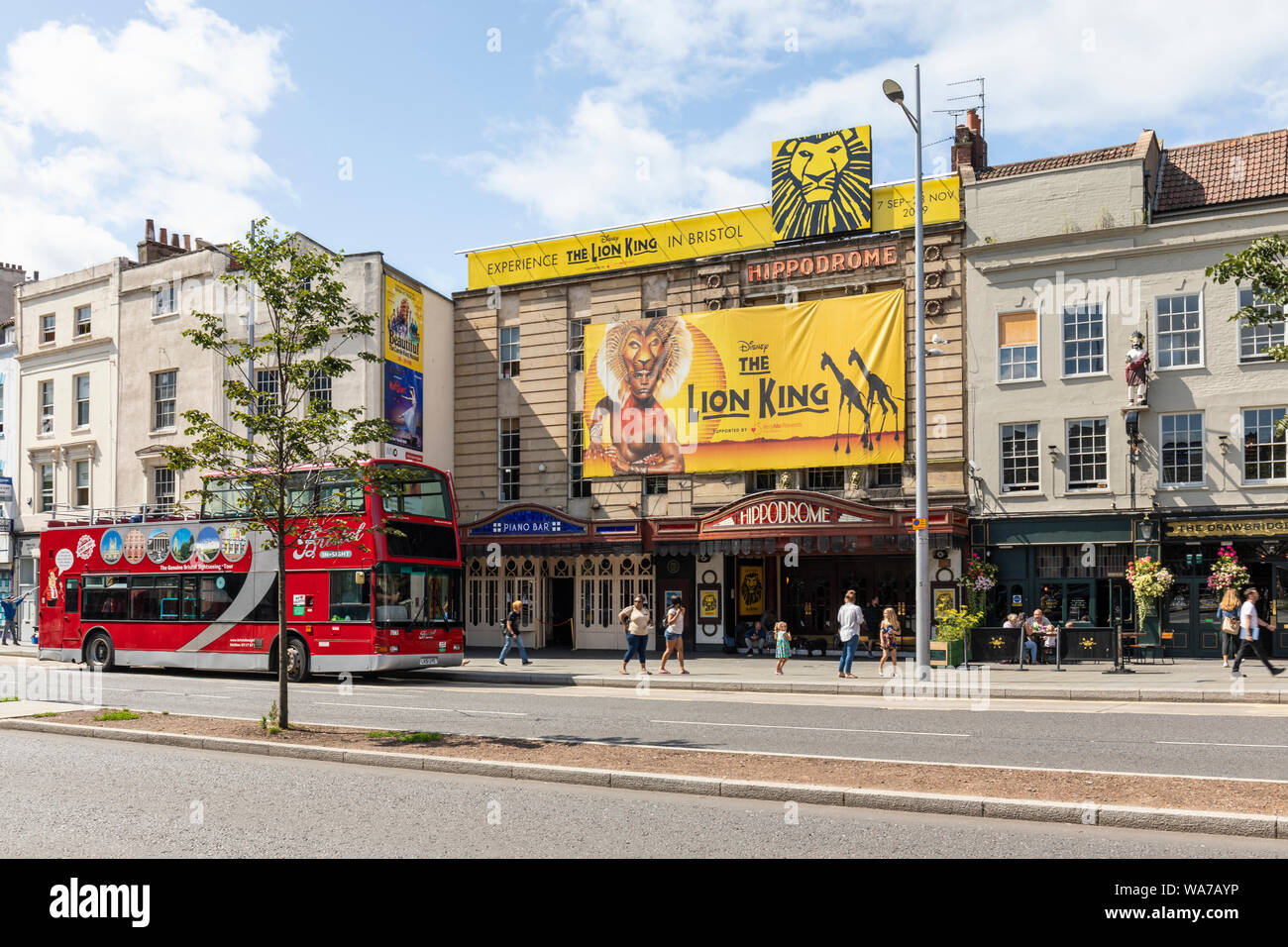 Bristol Hippodrome Theatre advertising Disney The Lion King with a Bristol Insight red open top bus outside, St Augustine's Parade, City of Bristol UK Stock Photo