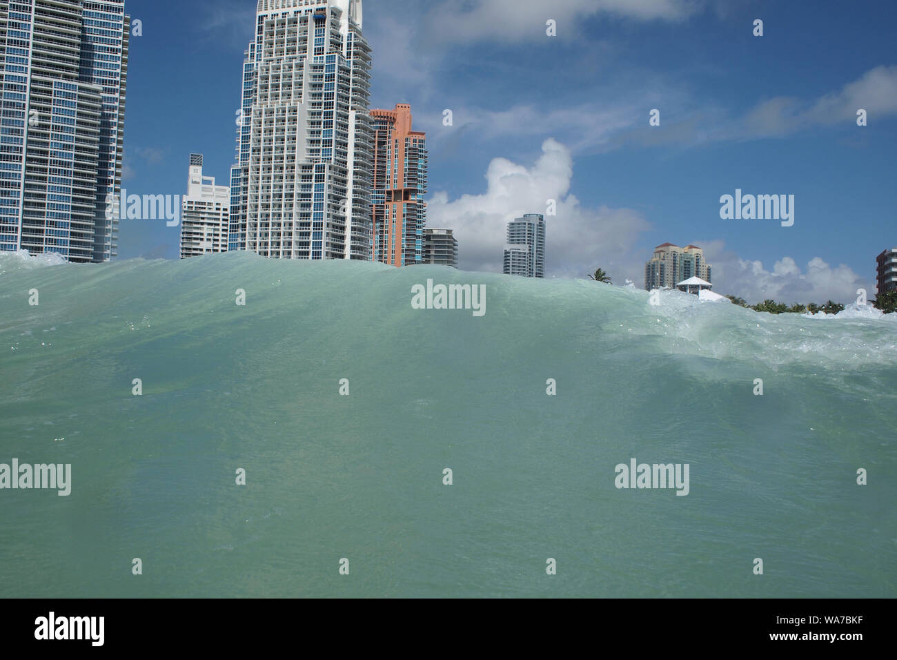 Ocean waves coming ashore at the South Beach in Miami, Florida, USA. Due to climate change, flooding became a problem for the low flat island. Stock Photo