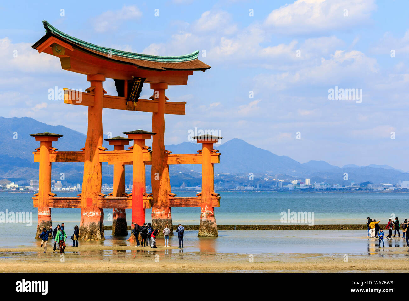 Japan, Miyajima. The Great Torii, or Otorii of the Itsukushima Shrine. Red  Torii on sand with tide out and many people walking around it Stock Photo -  Alamy