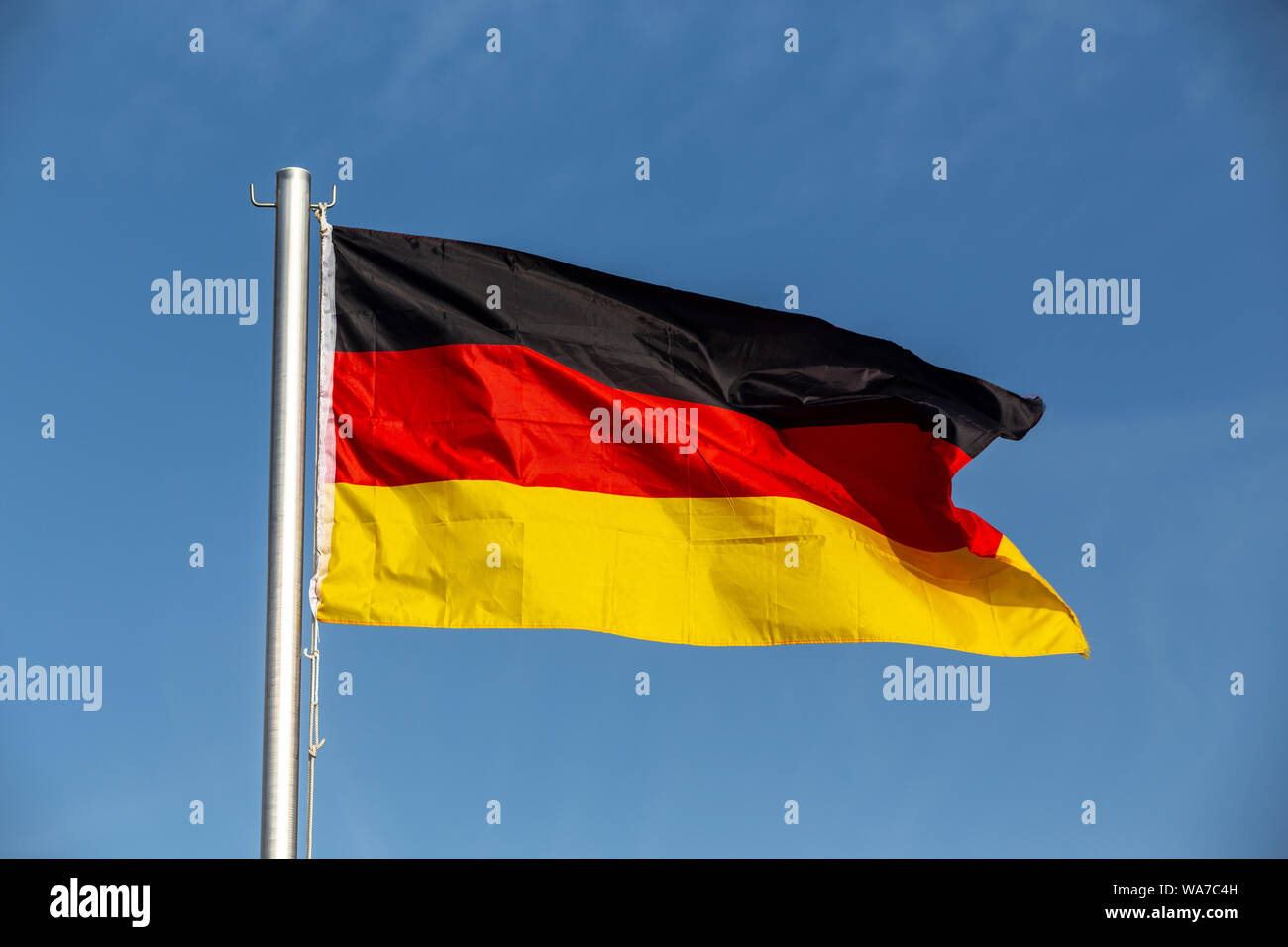 German flag against blue sky Stock Photo