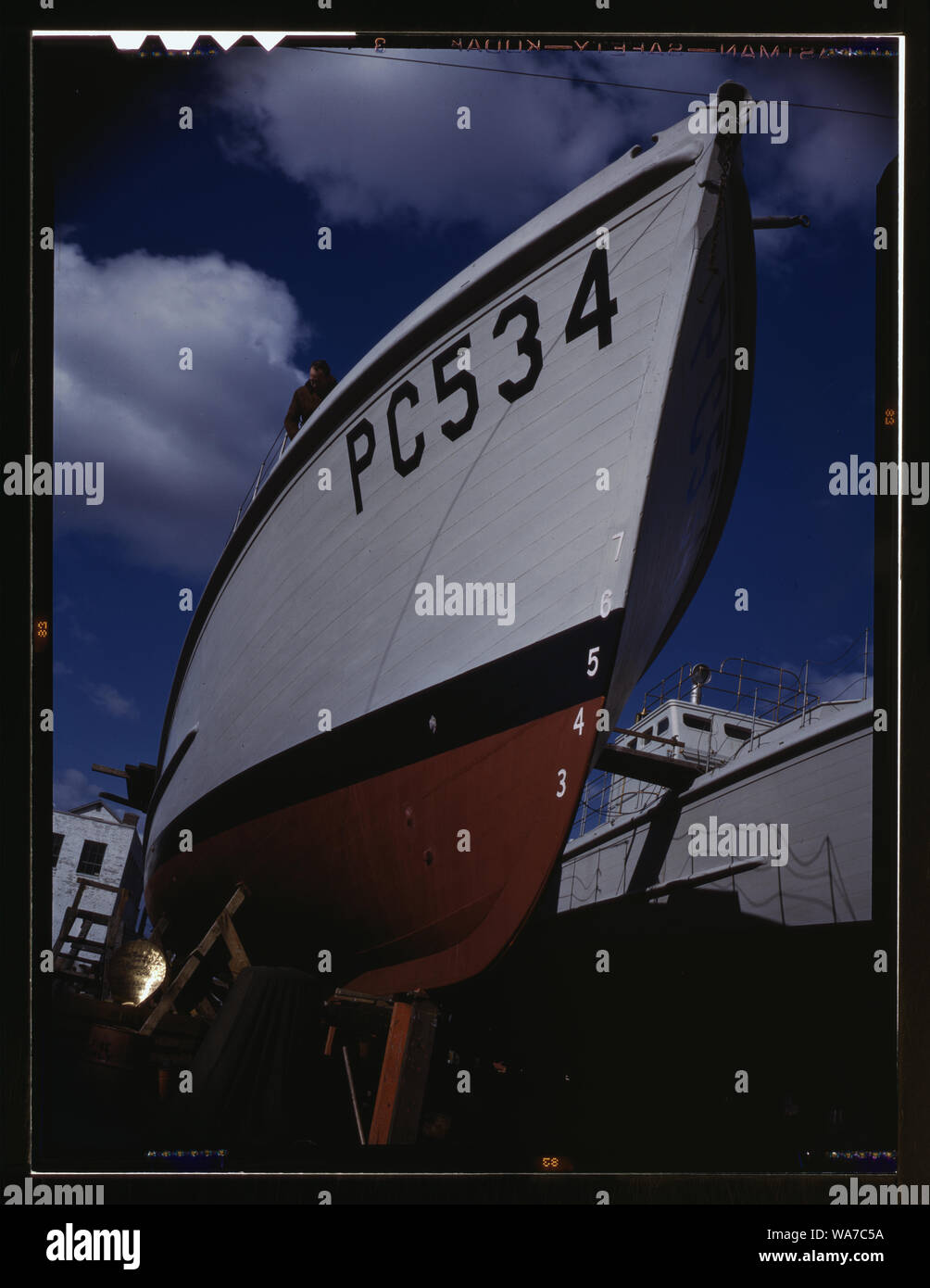 Another harrier of the U-boats nears completion at an eastern boat yard, Marine Construction Co., Stamford, Conn. Many new 110-foot wooden sub-chasers are taking the water these days at yards in all parts of the country Stock Photo