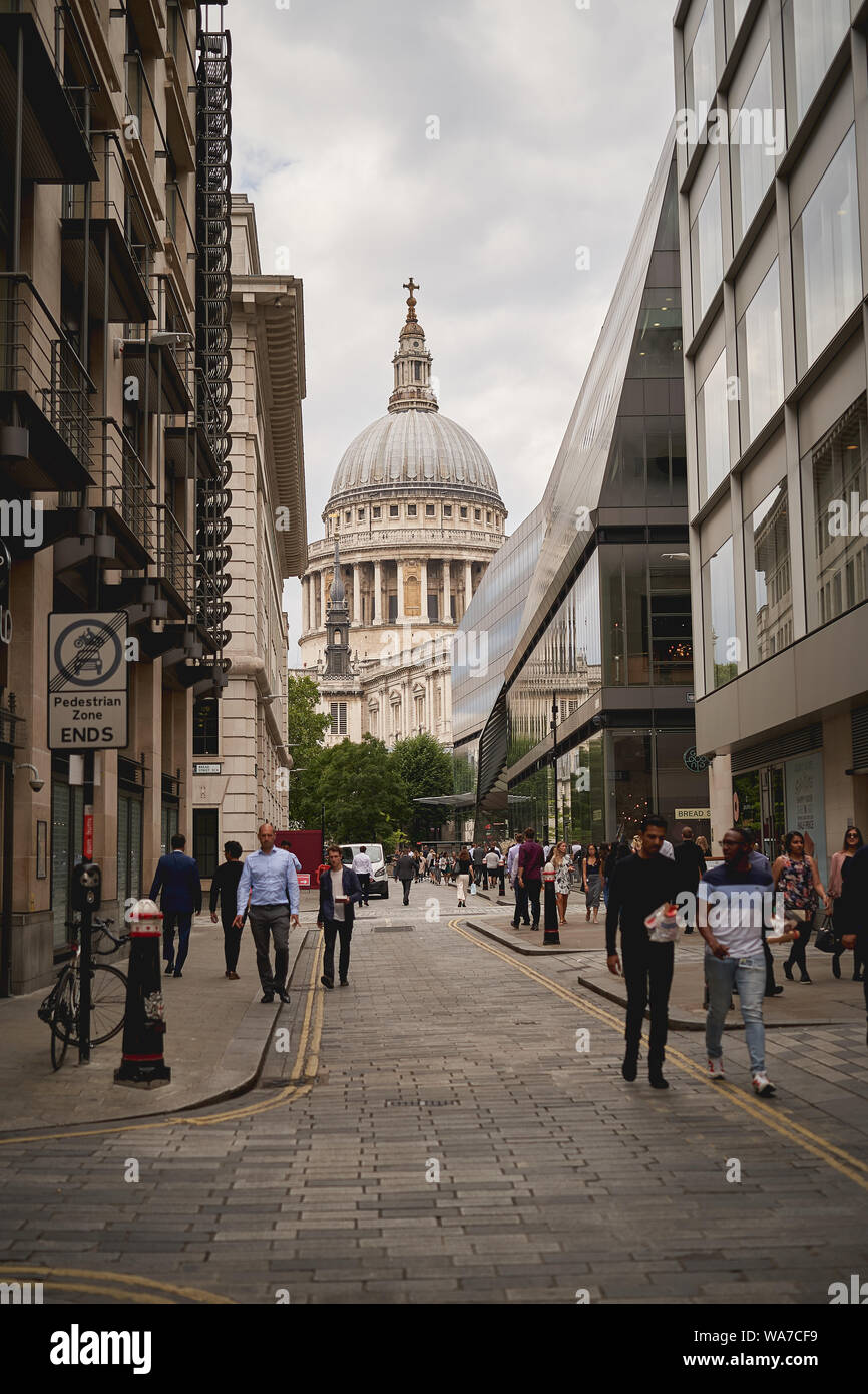 London, UK - August, 2019. Watling Street in the hearth of the City of London full of people during office lunch break, with St. Paul's Cathedral. Stock Photo