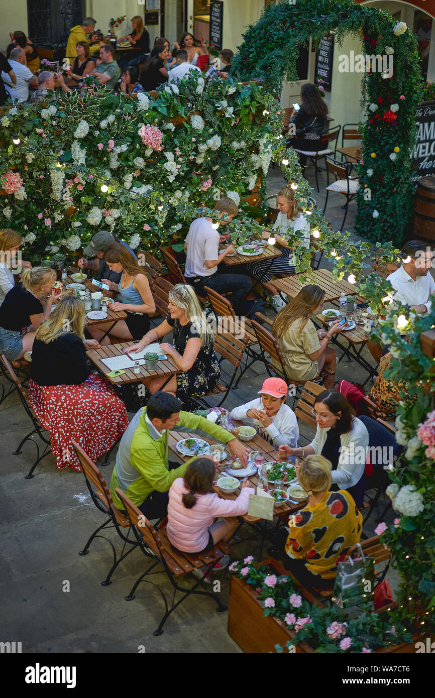 London, UK - August, 2019. People having drink and brunch in a restaurant in Covent Garden. Stock Photo