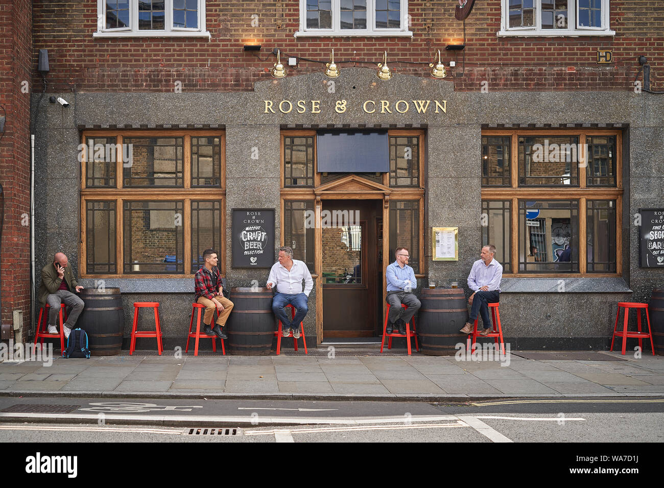 London, UK - August, 2019. People having drinks outside a pub in central London. Stock Photo