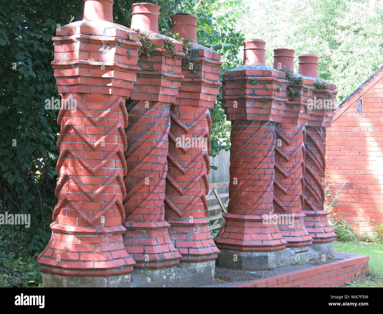 This row of six ornate twisted 'barley sugar' chimneys with their spiral and chevron patterns were originally on a Cardiff cottage in the 1890s. Stock Photo