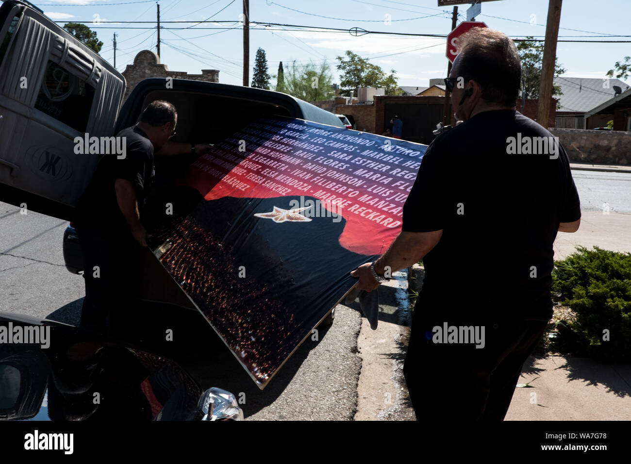 People Load A Banner Into A Hearse At The La Paz Faith Memorial