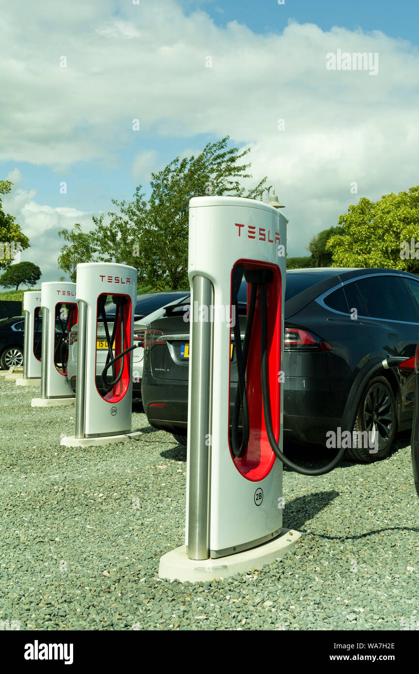 Tesla Electric vehicle charging Points. Darts Farm, Topsham Devon UK Stock Photo
