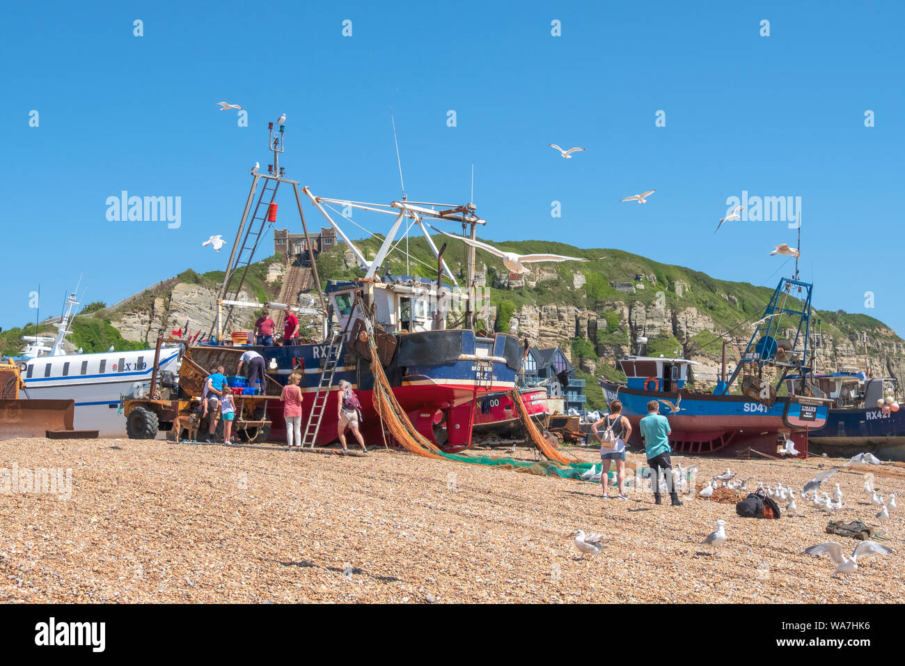 Hastings fishing trawler landing catch of fish on the Old Town Stade fishing boat beach, East Sussex, UK fishing boats Stock Photo