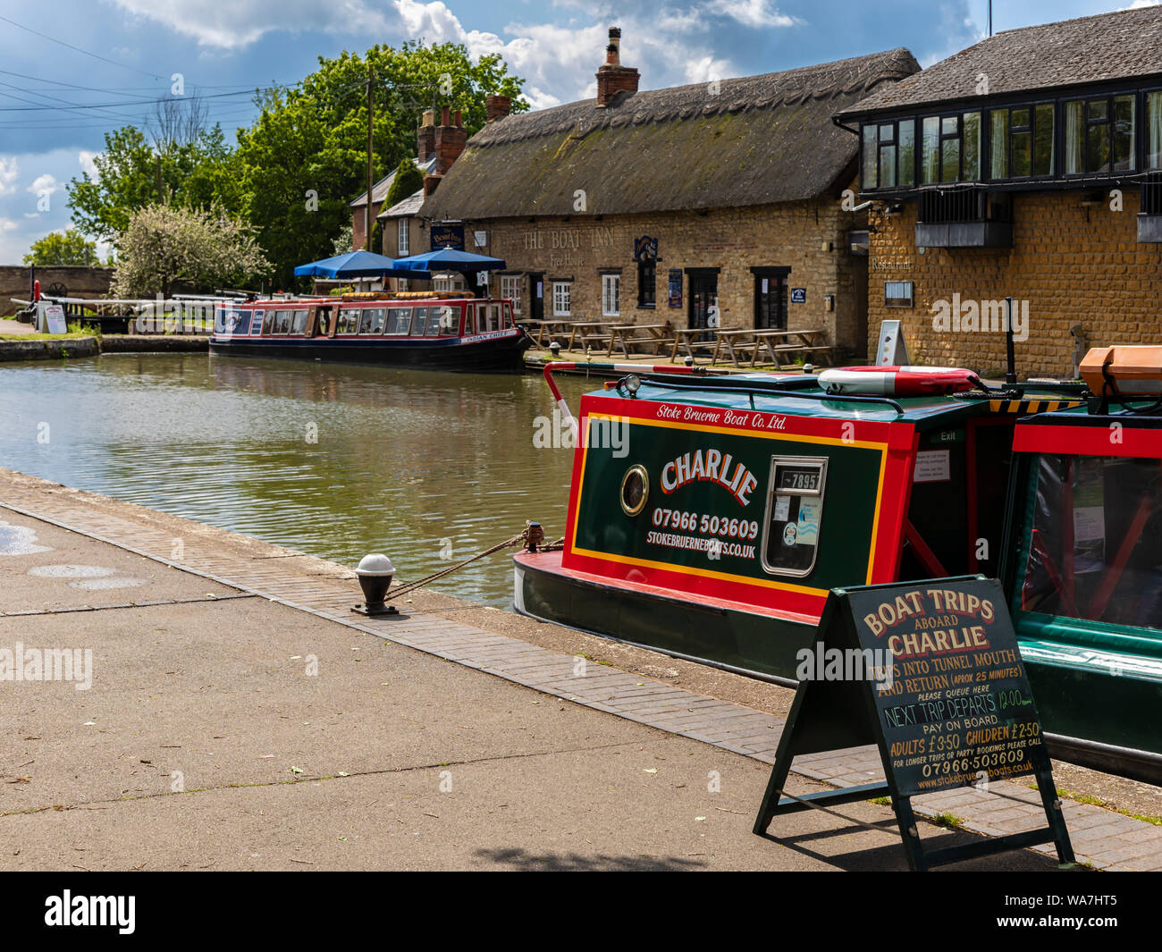 STOKE BRUERNE, NORTHAMPTONSHIRE, UK - MAY 10, 2019:  Narrowboats moored on the Grand Union Canal offering Day Trips Stock Photo