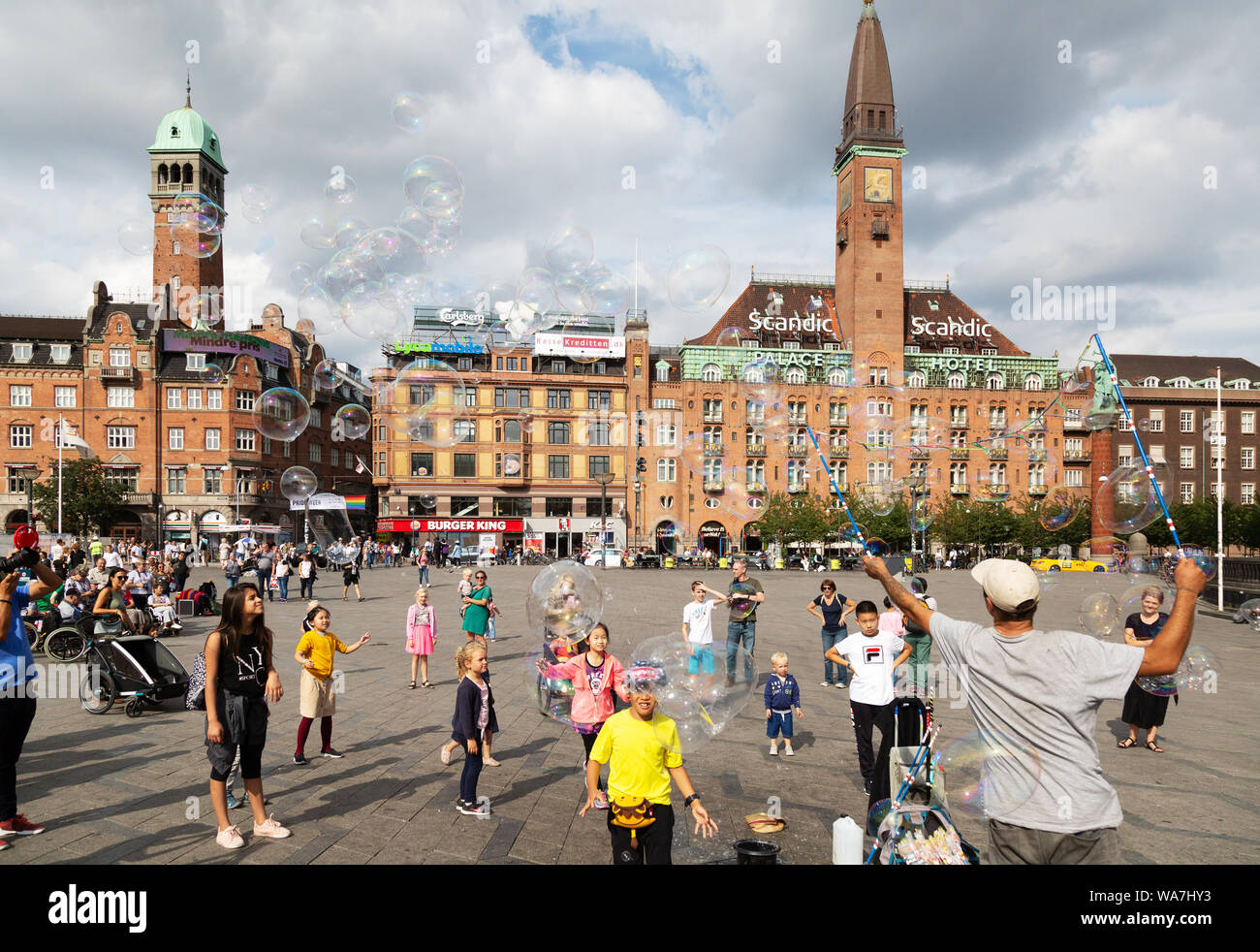 A man blowing bubbles for the local children in summer, City Hall