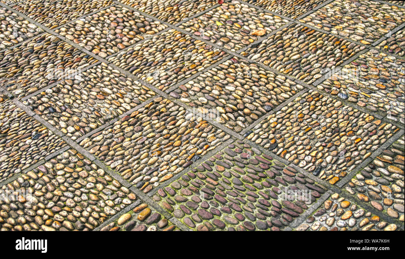 Artistic and decorative paving stones made using pebbles Stock Photo