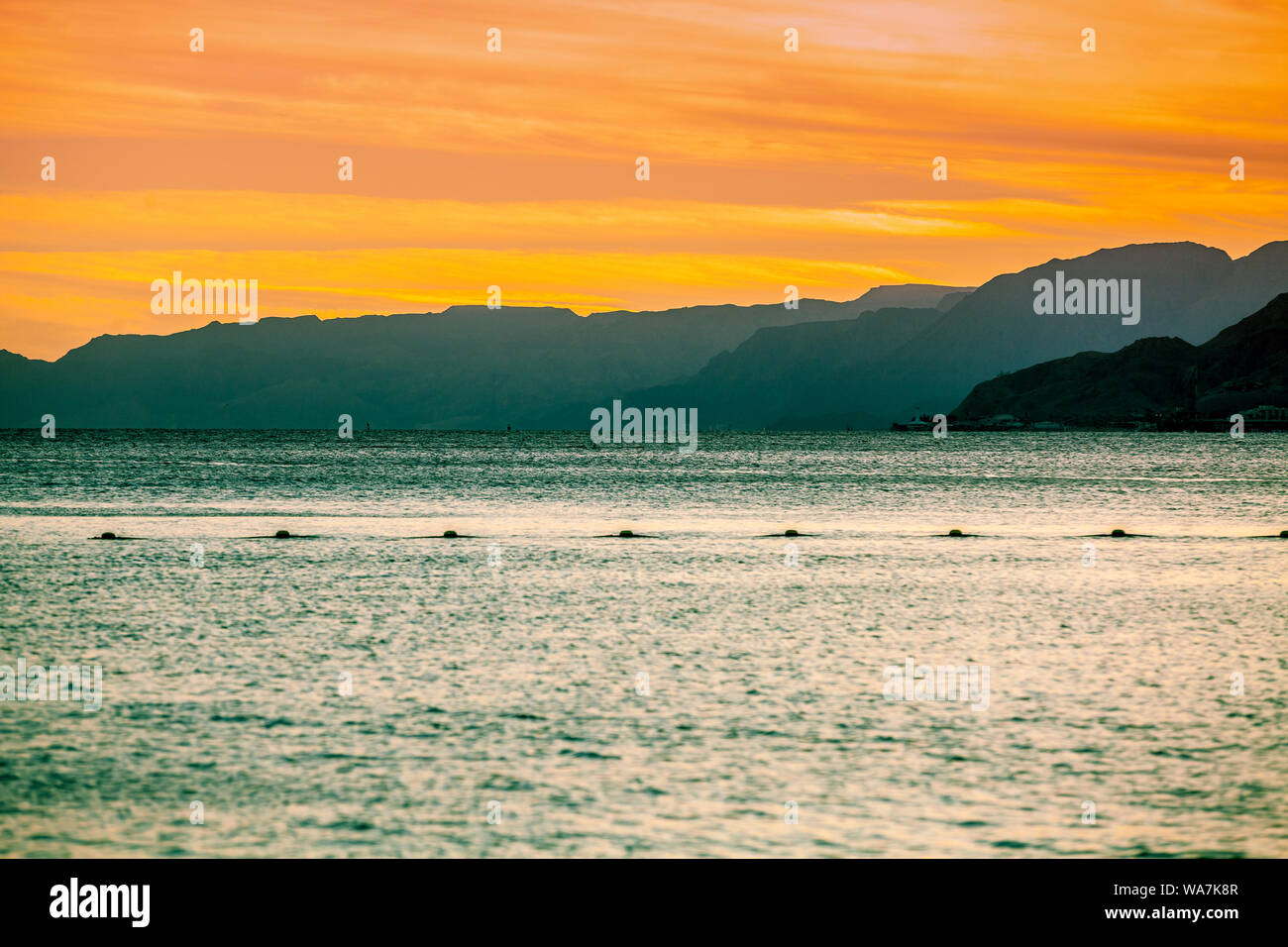 Sunset over the Red Sea in Eilat, Israel. Beautiful evening sea landscape. View of the sea and mountains Stock Photo