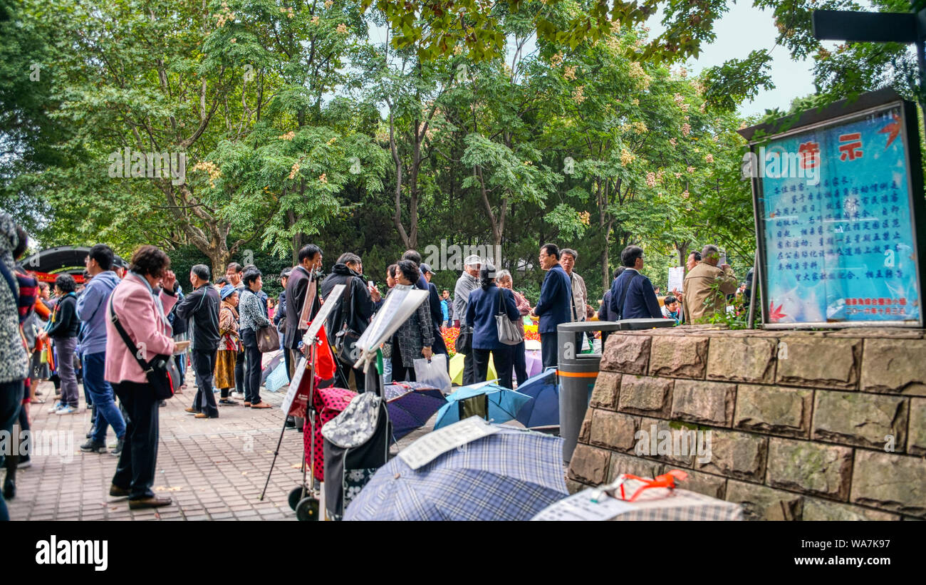 The Marriage Market in the park at People’s Square. Parents of unwed adult children provide information to try to find a suitable mate. Shanghai Stock Photo