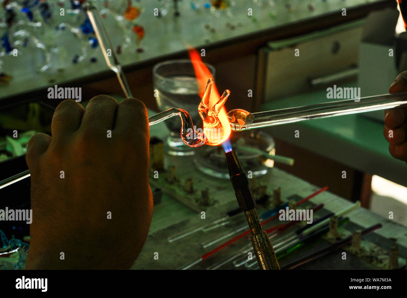 Artisan Hands working with hot glass Stock Photo