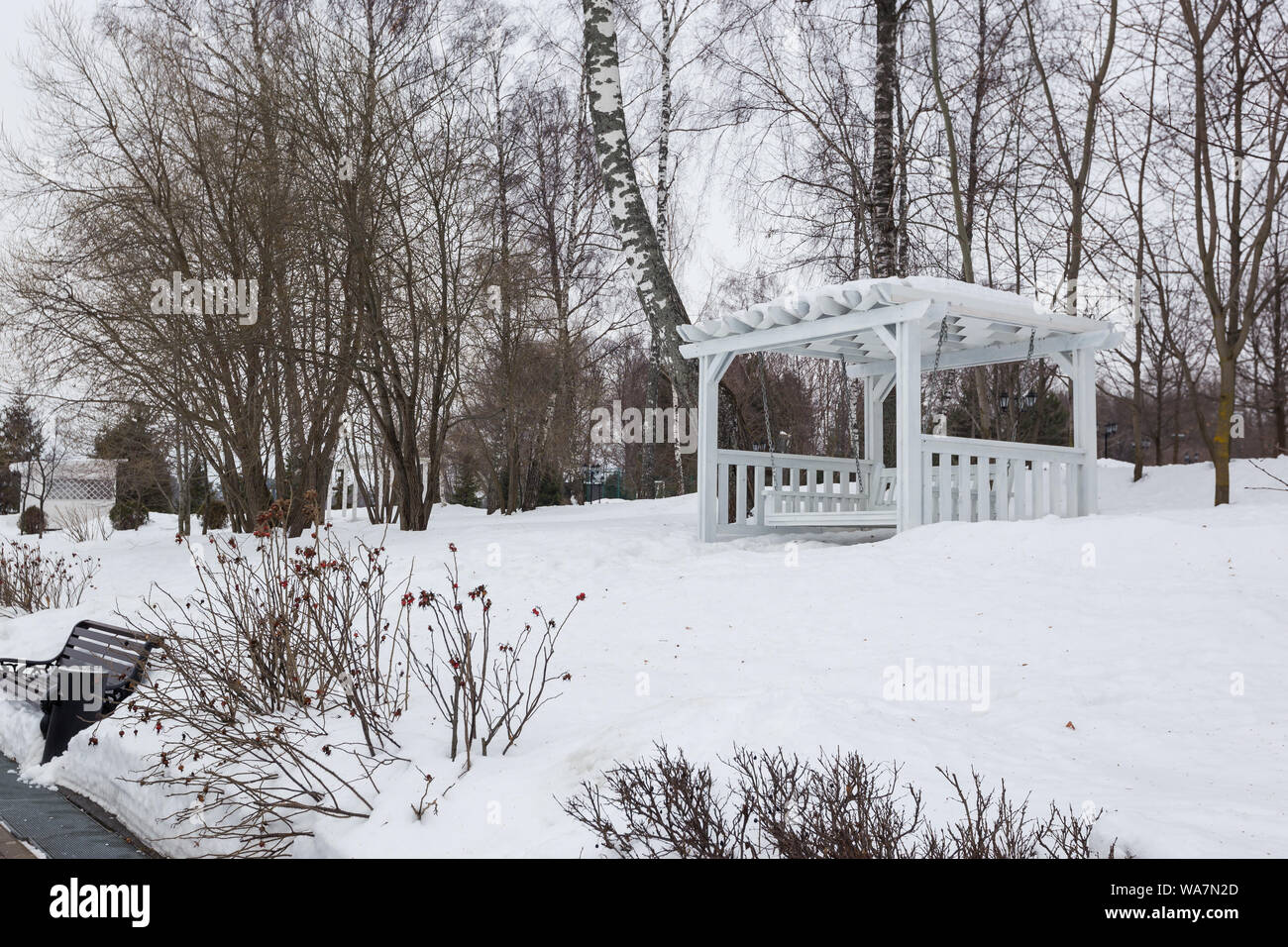 Park benches and trees covered by heavy snow in winter. Lots of snow ...