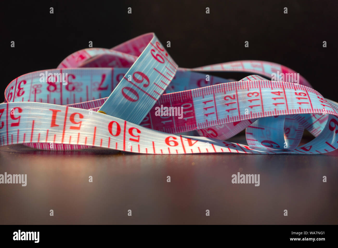 Measuring tape pile. Tailor instrument background Stock Photo - Alamy