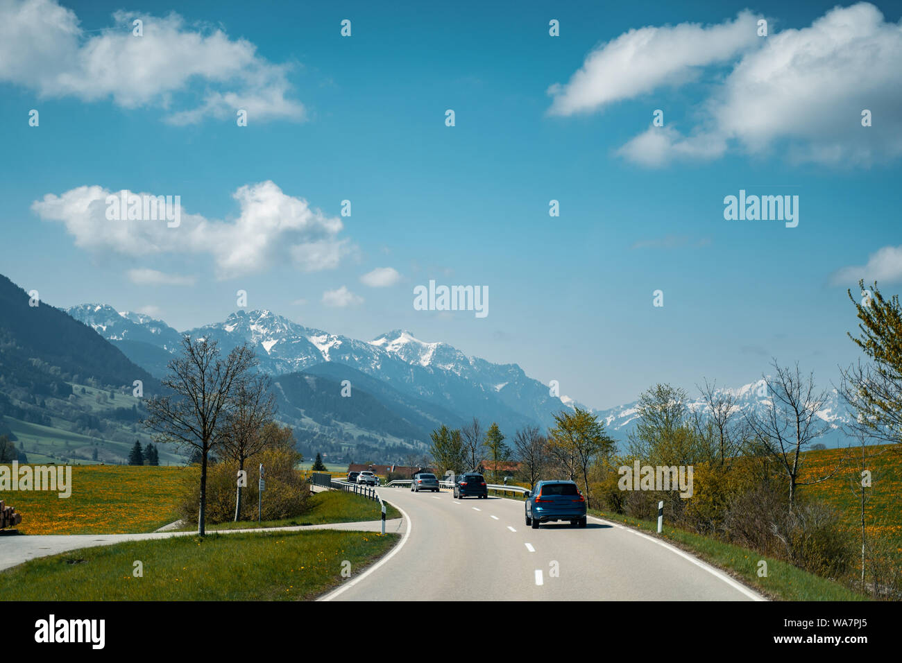 Car driving on the highway with mountains in the background Stock Photo ...