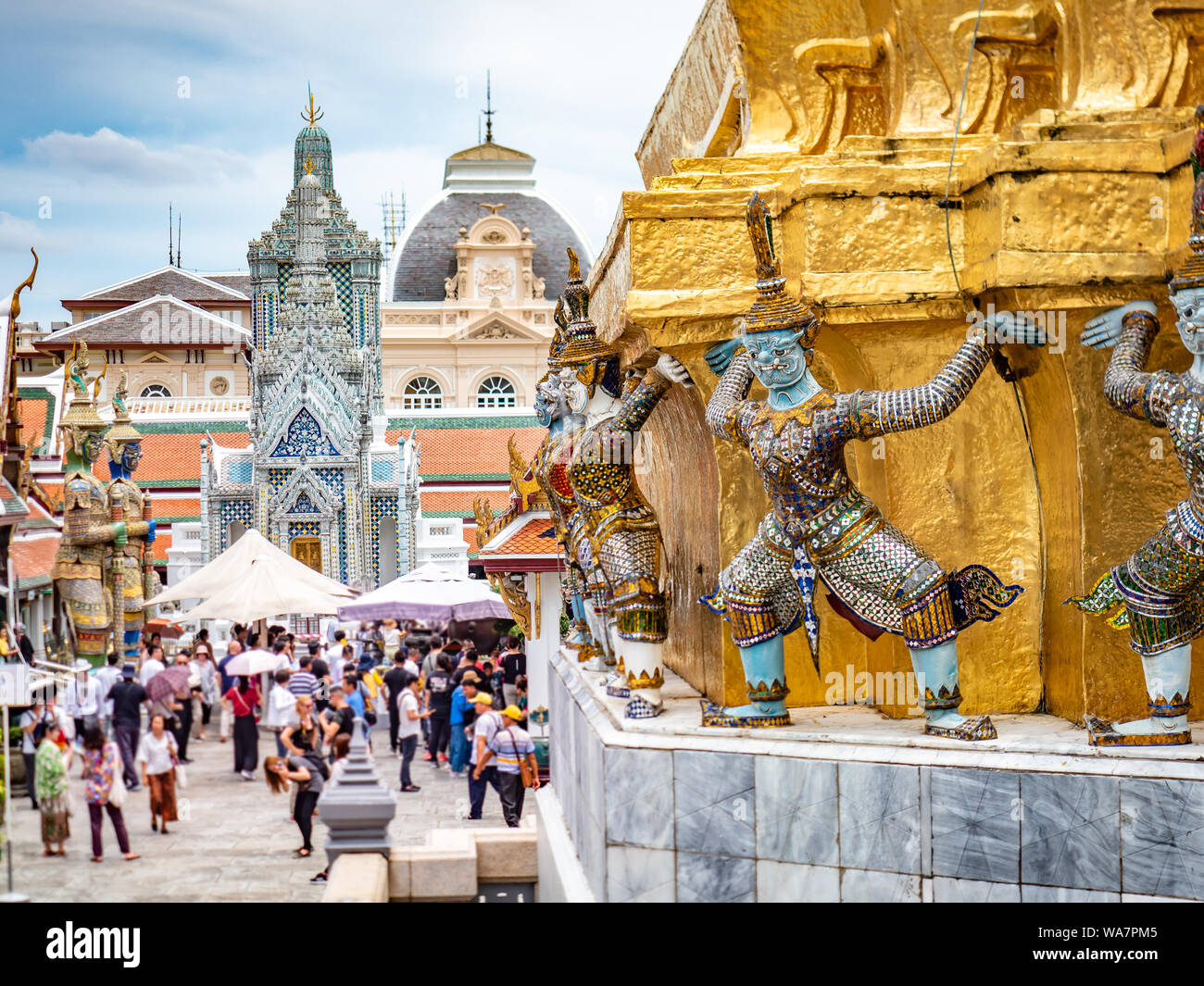 Golden monuments and Temple of Emerald Buddha, Grand Royal Palace in Bangkok, Thailand. Official residence of the Kings of Siam. Museum crowd tourists Stock Photo